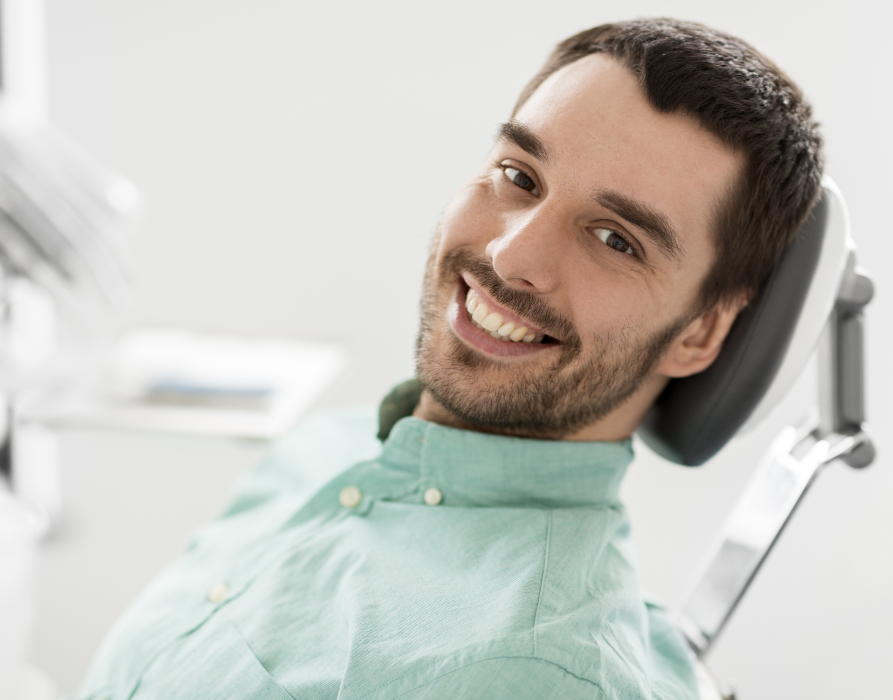 Apex man smiling in dental chair after exam