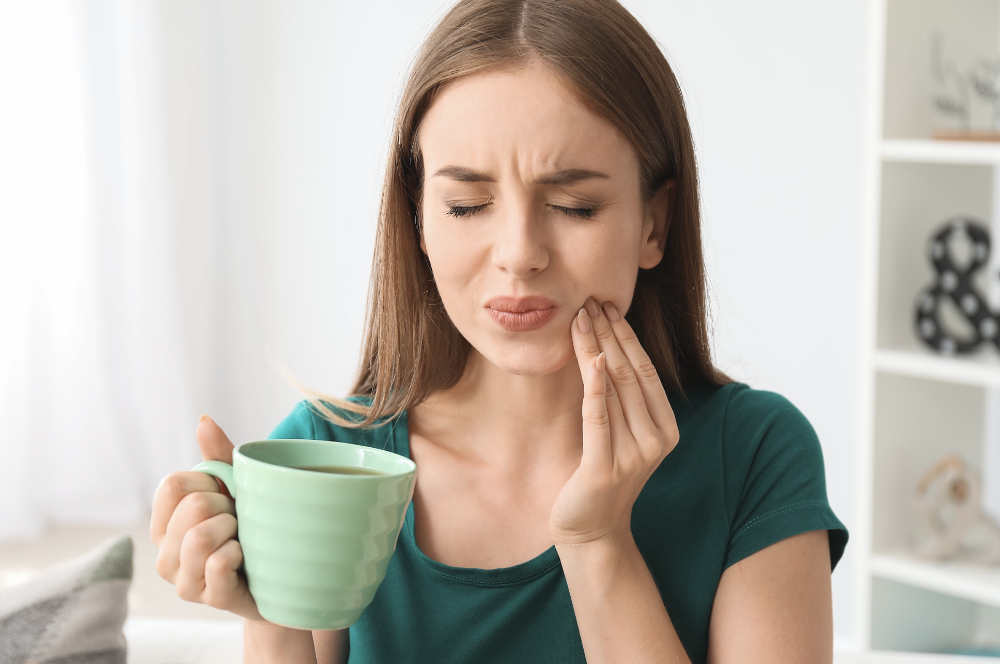 woman holding her jaw | tooth extraction apex, nc