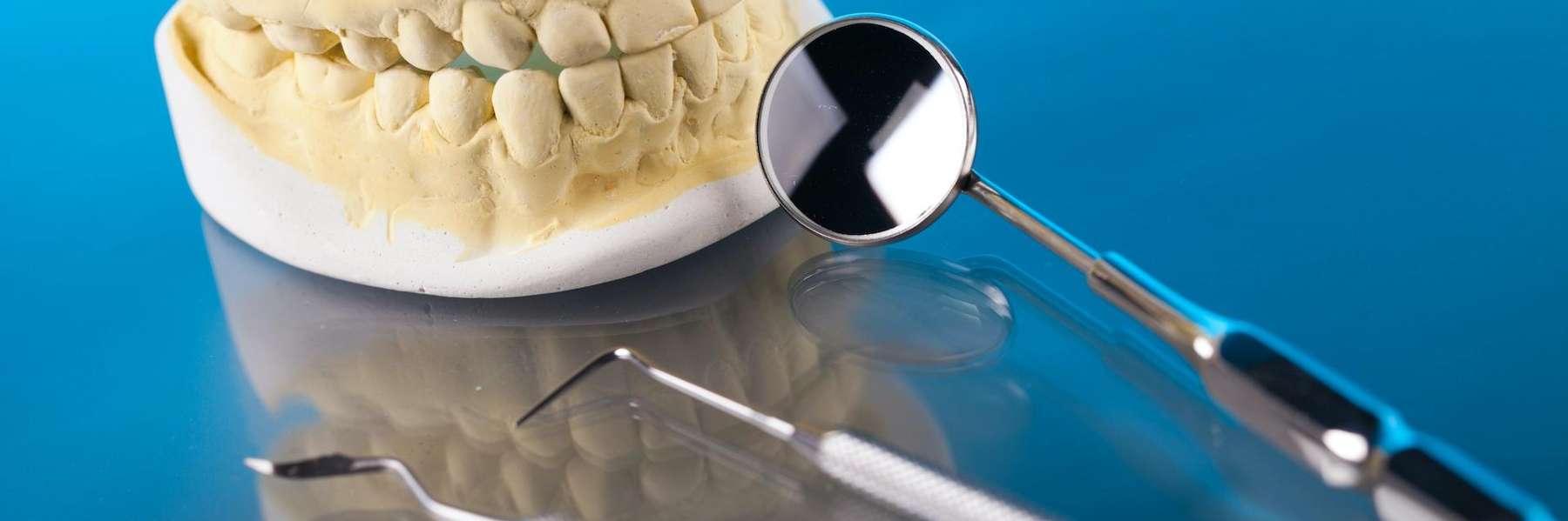 A dental mirror and a tooth model in Apex, NC
