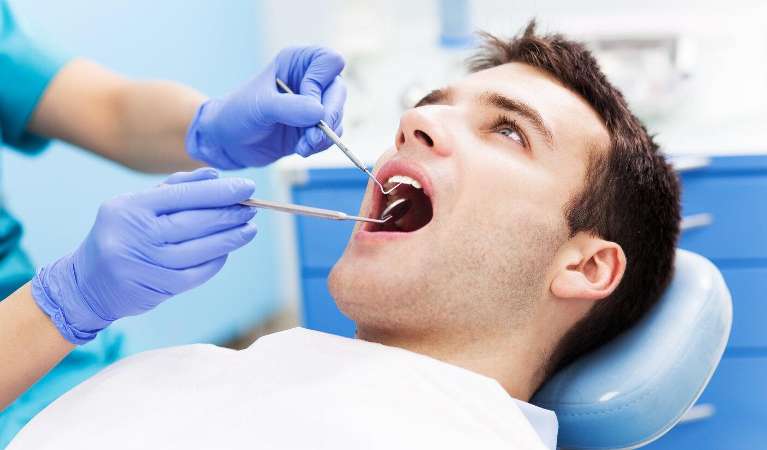 Man getting dental cleaning in apex nc
