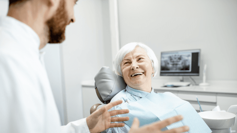 an elderly lady getting ready for a Dental Bridges in Apex, NC