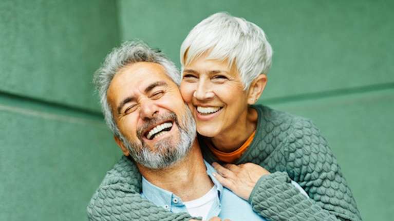 middle aged man and woman smiling 