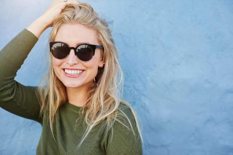 A woman smiling after getting Cosmetic treatment in Apex, NC