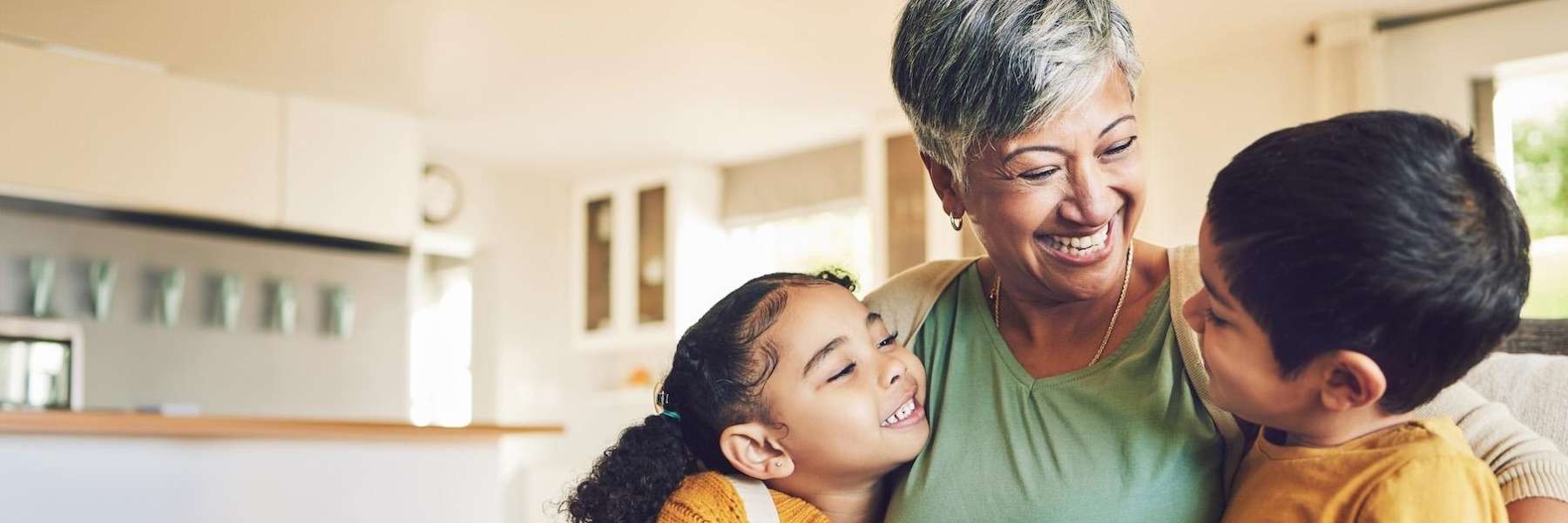 An image of a mother with her two kids, smiling after getting Partial Dentures in Apex NC