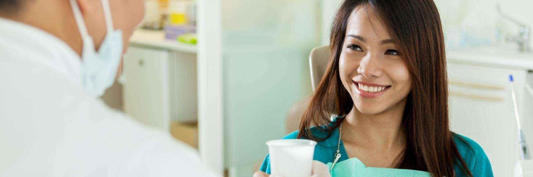 woman smiling after tooth extractions