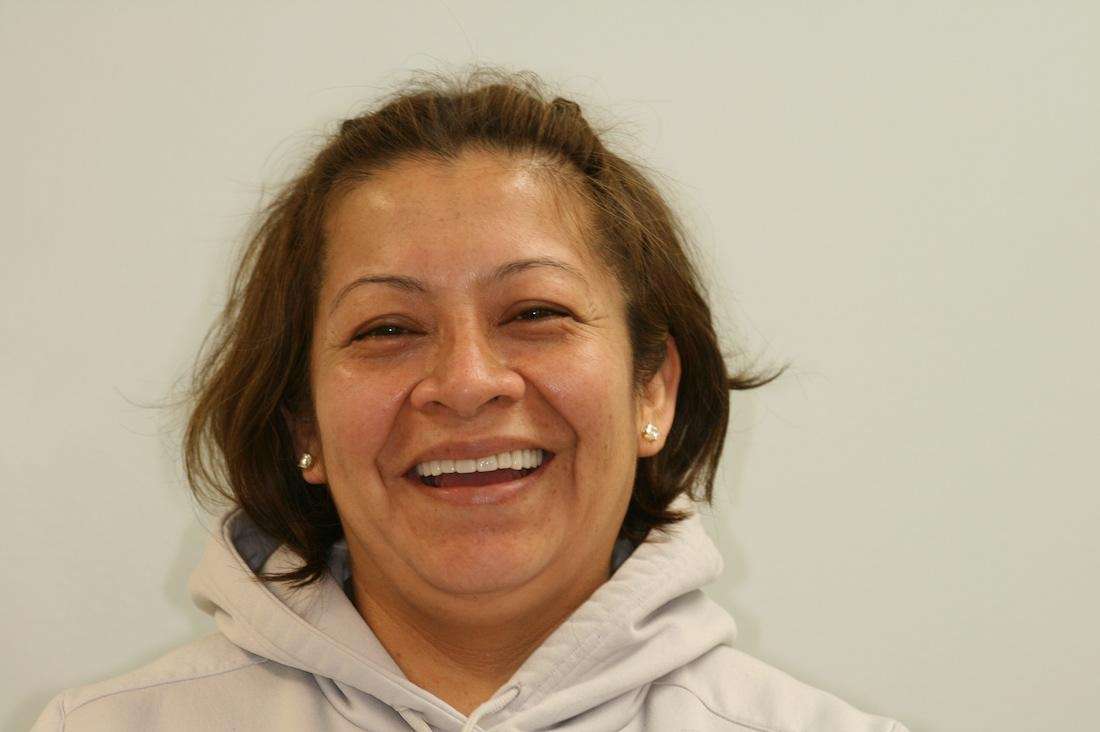 female patient smiling wide after dental work
