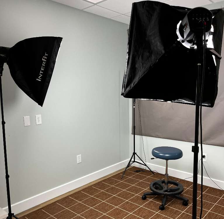 photo studio with lights and a stool