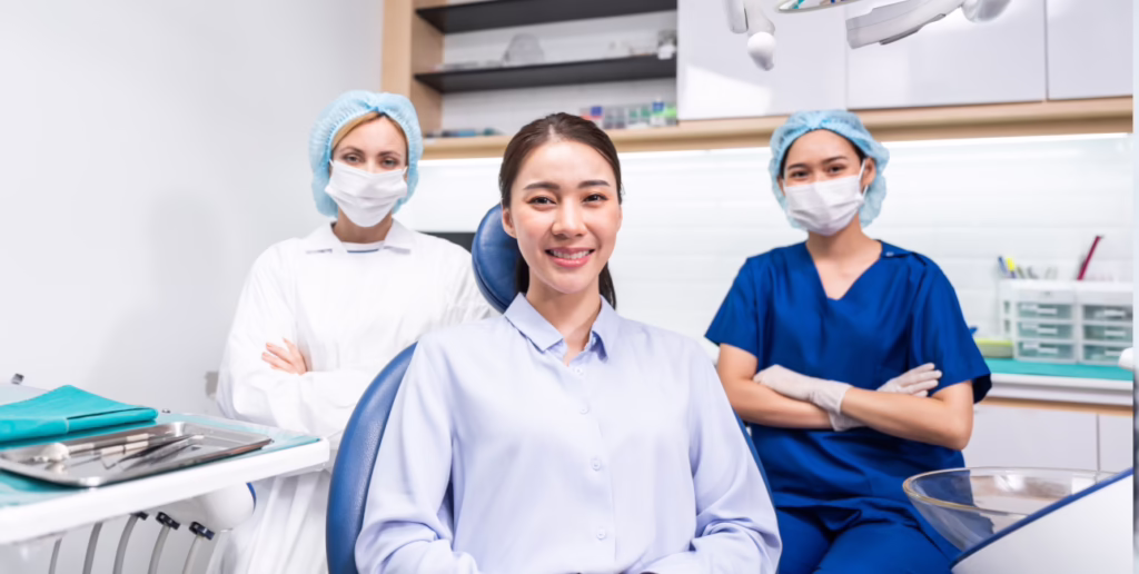 Patient seated with a dental care team in a treatment room