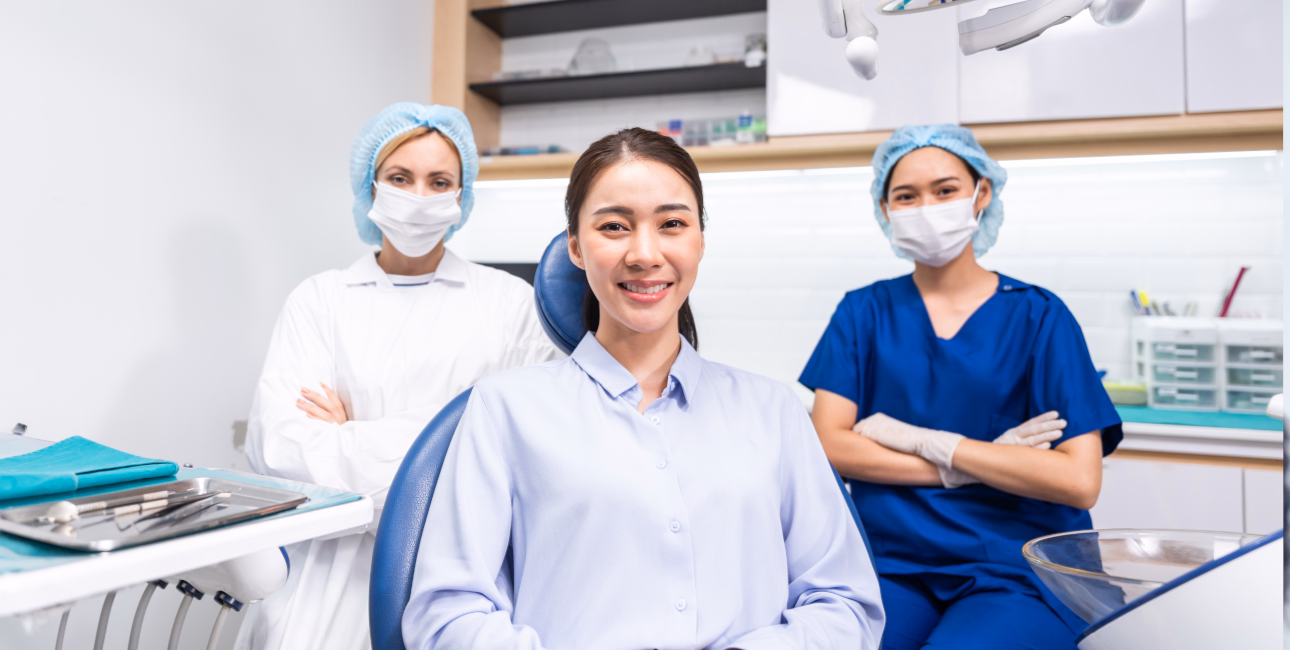 Patient seated with a dental care team in a treatment room