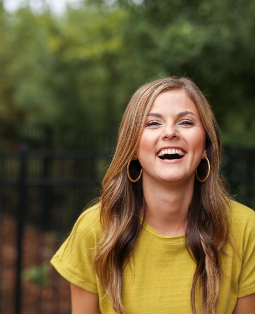 Woman laughing outdoors