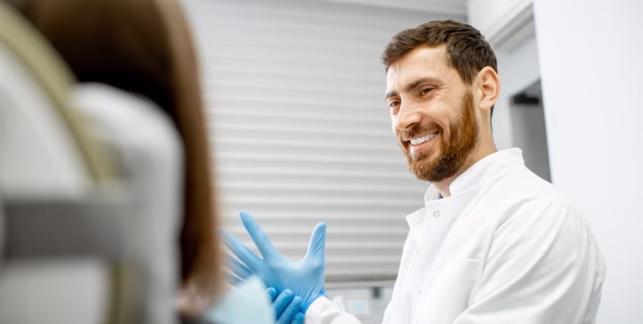 Dentist putting on gloves before a dental procedure