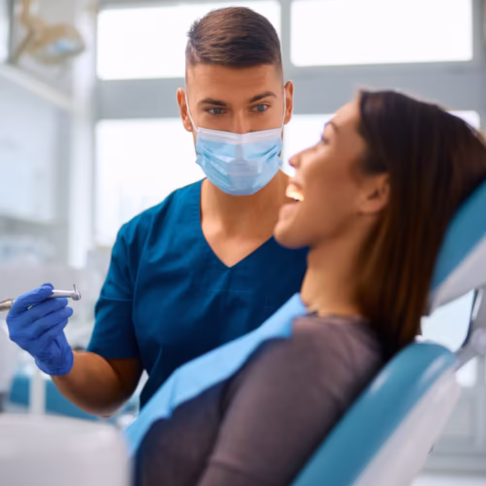 Dentist speaking with a female patient in a dental chair
