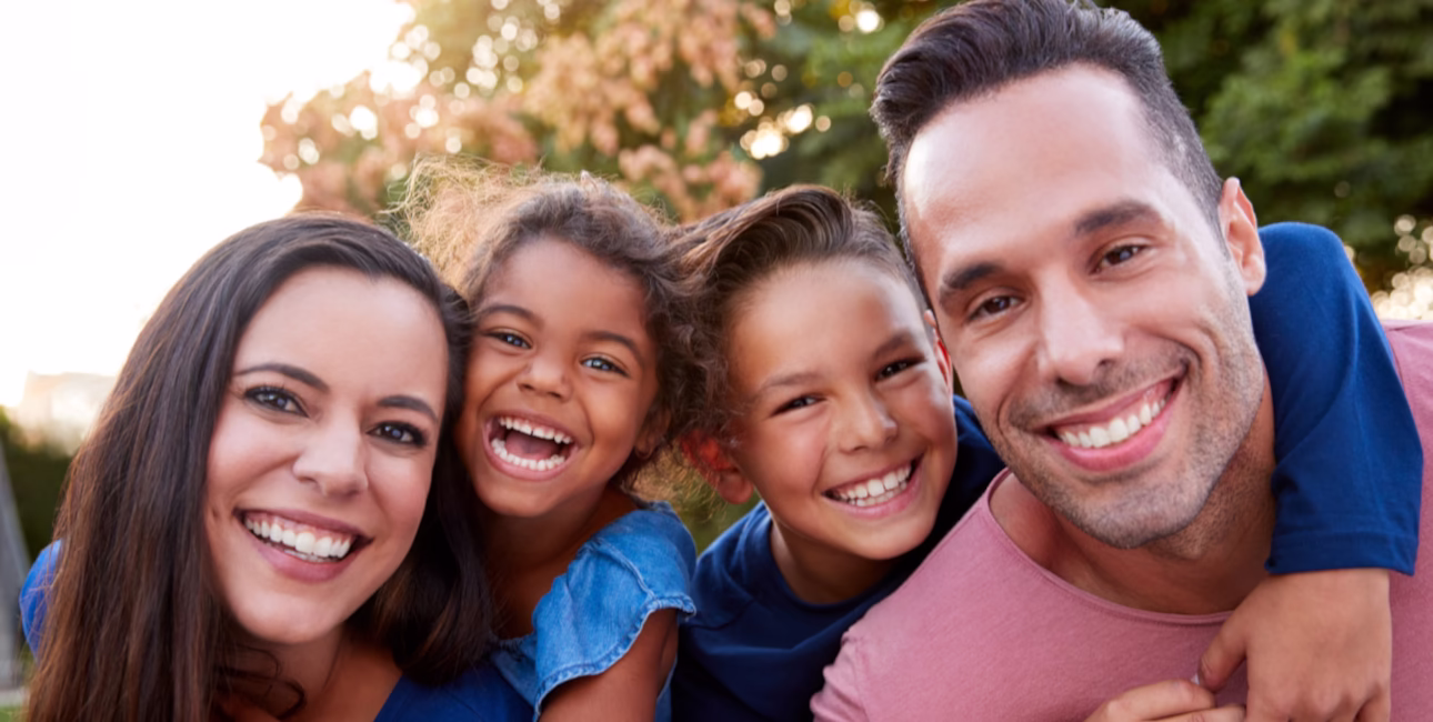 Family with two children smiling together