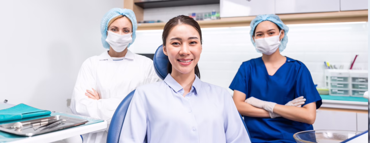 Patient seated with a dental care team in a treatment room