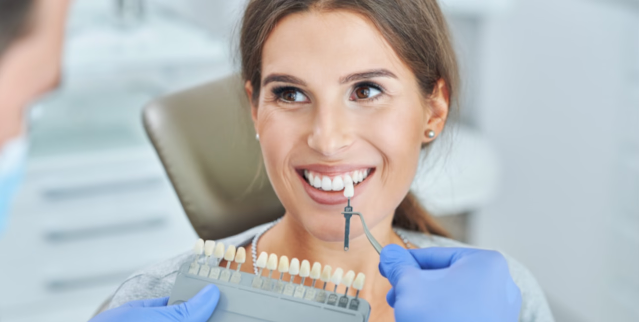 Patient comparing veneer shades during a cosmetic dental consultation